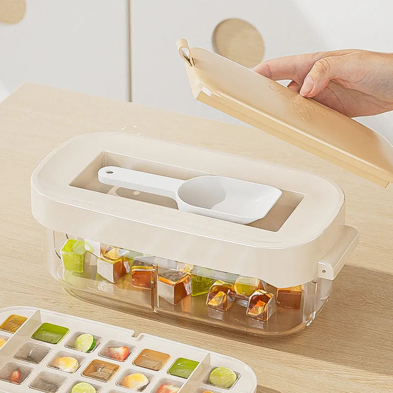 High-capacity plastic ice cube tray in blue with an ice shovel stored in a dedicated slot on the tray.