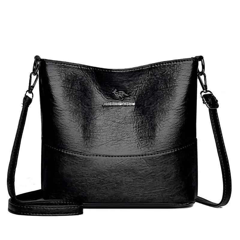 Women's soft leather shoulder bag in bucket design with minimalist luxury styling and mobile phone pocket