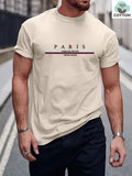 Man wearing a loose-fit short-sleeved t-shirt with a large letter print on the chest in a solid colour.