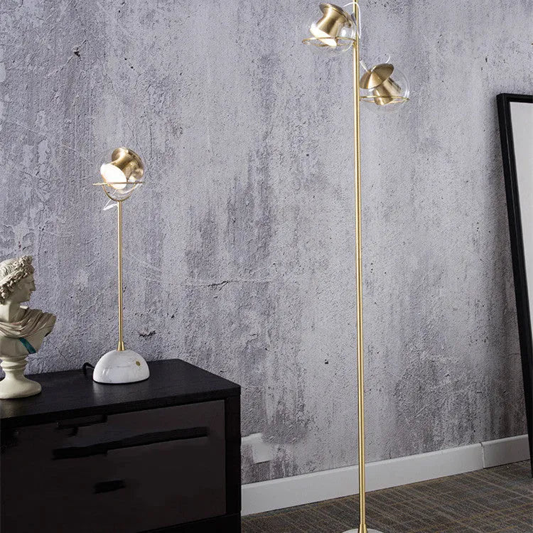 Clear glass dimmable desk lamp with touch switch on a wooden desk.
