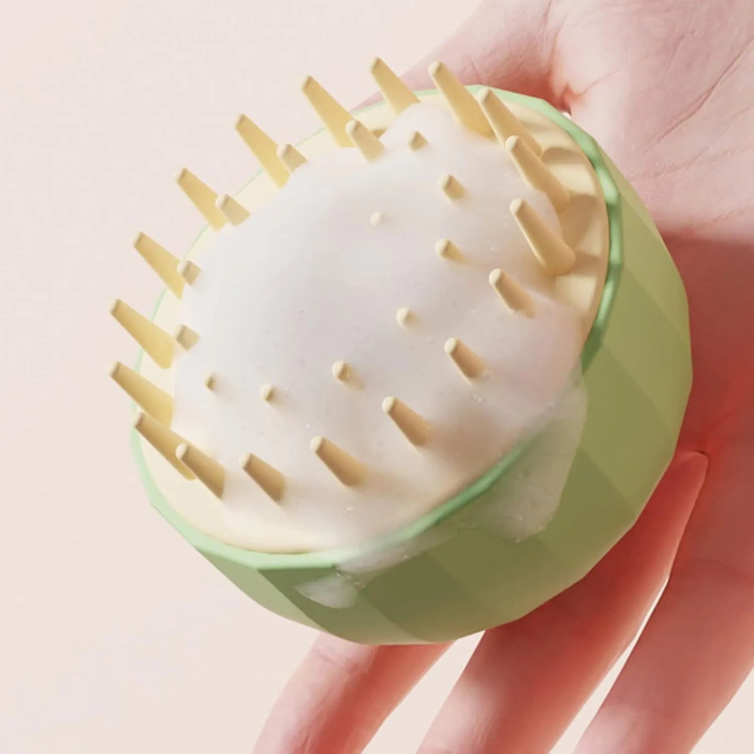 Green double-sided pet bath massage brush with drainage holes on a white background