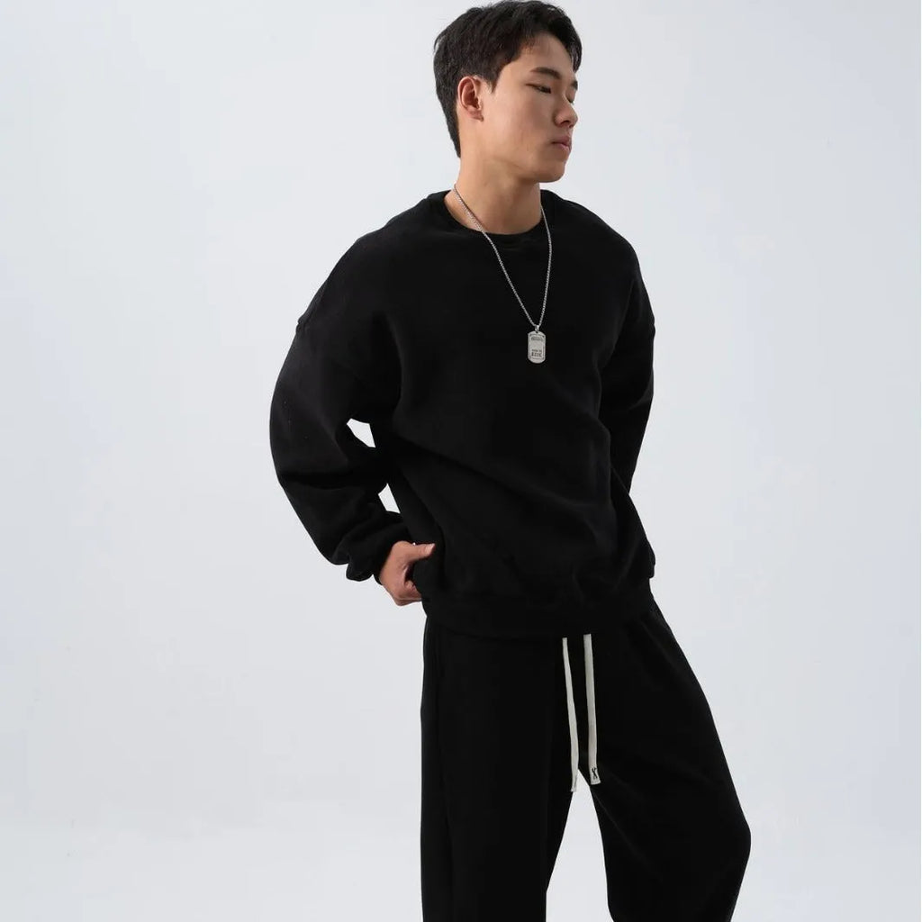Men's black polar fleece sports suit with long sleeve crew neck coat and loose fit trousers.