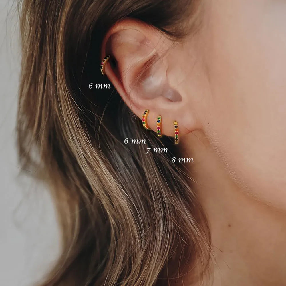 A pair of round perforated circle zircon stud earrings in gold, rose gold, and silver colour options.