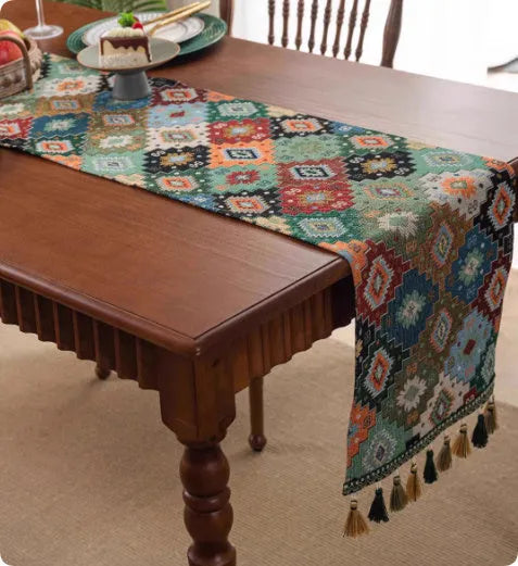 A retro style table flag with handwoven tassels in a blue ginkgo leaf pattern on a table.