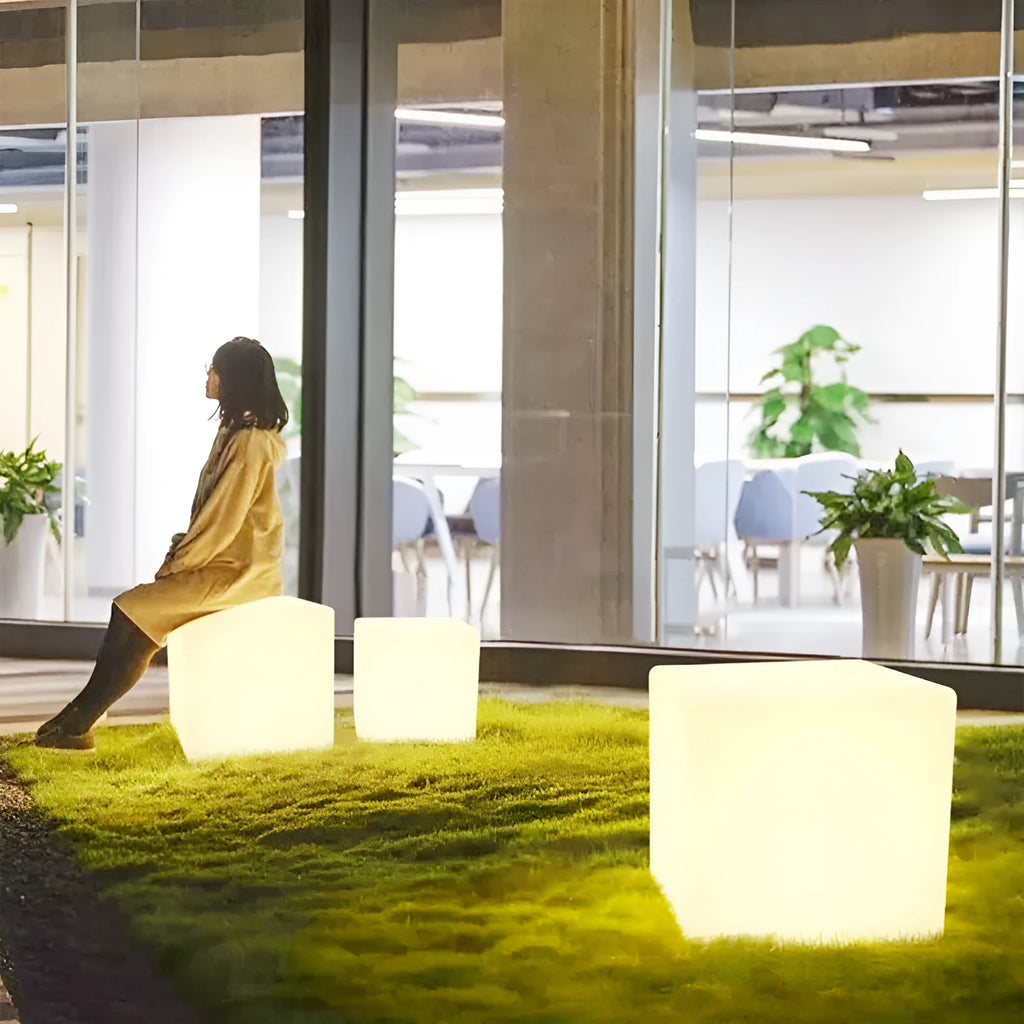 Modern square white LED cube stool light for garden patio with solar panel on top.