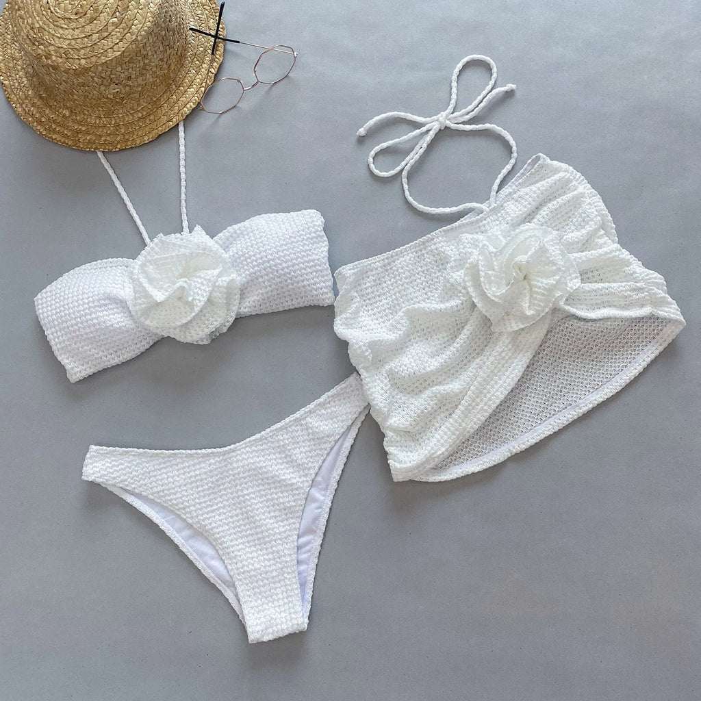 Women's purple and white 3D flower split swimsuit bikini three-piece set on a mannequin.