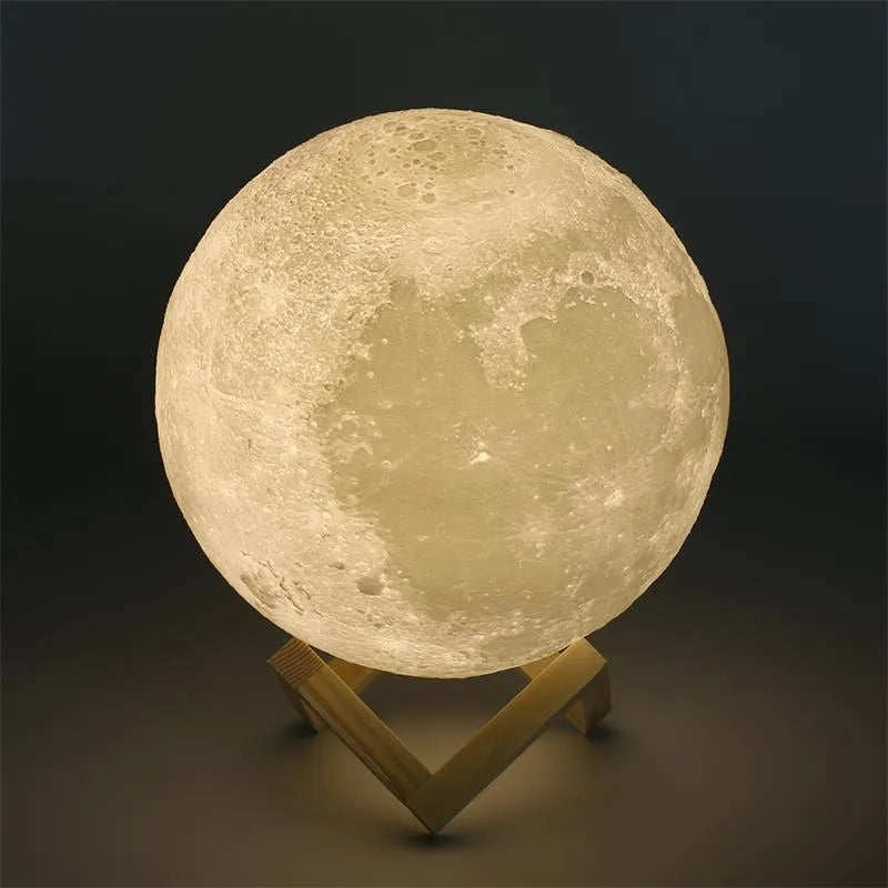 3D printed white moon lamp on a wooden stand, showing detailed craters and soft LED glow.