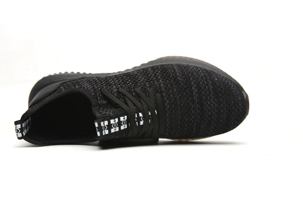 Low-cut black safety work shoes with a steel toe cap and EVA midsole on a grey background.
