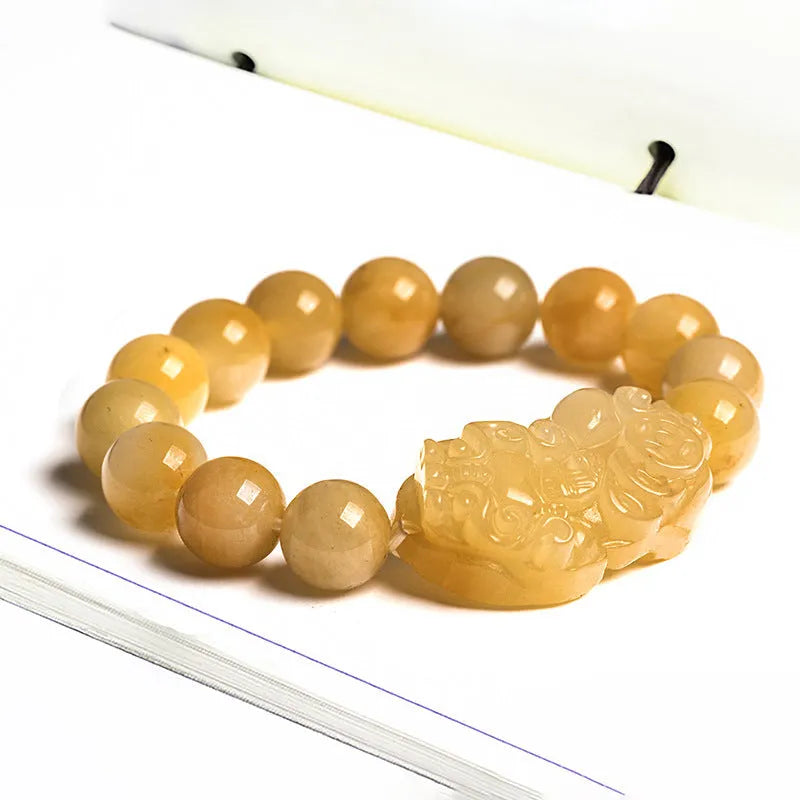 Hand-carved Golden Thread Jinsi Jade money bracelet showing carved detail, offered in large and small unisex sizes.