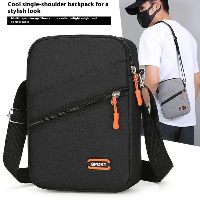 Lightweight Oxford cloth crossbody commuter bag in a solid colour with contrast detail.