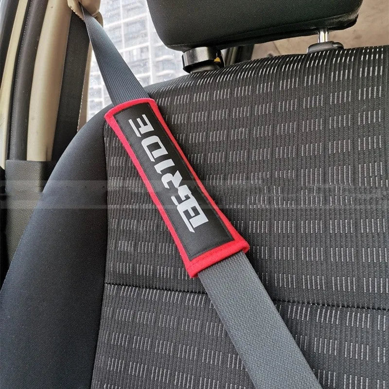 Car seatbelt shoulder pads in black, blue, and red colours showing cotton and sponge cloth embroidery weave construction