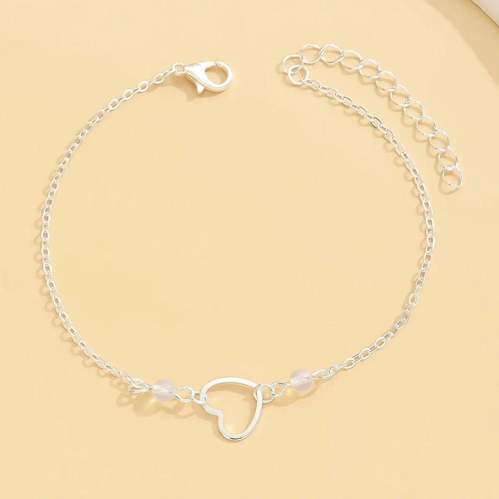 Adjustable women's anklet with heart-shaped geometric pendant in gold or silver alloy metal