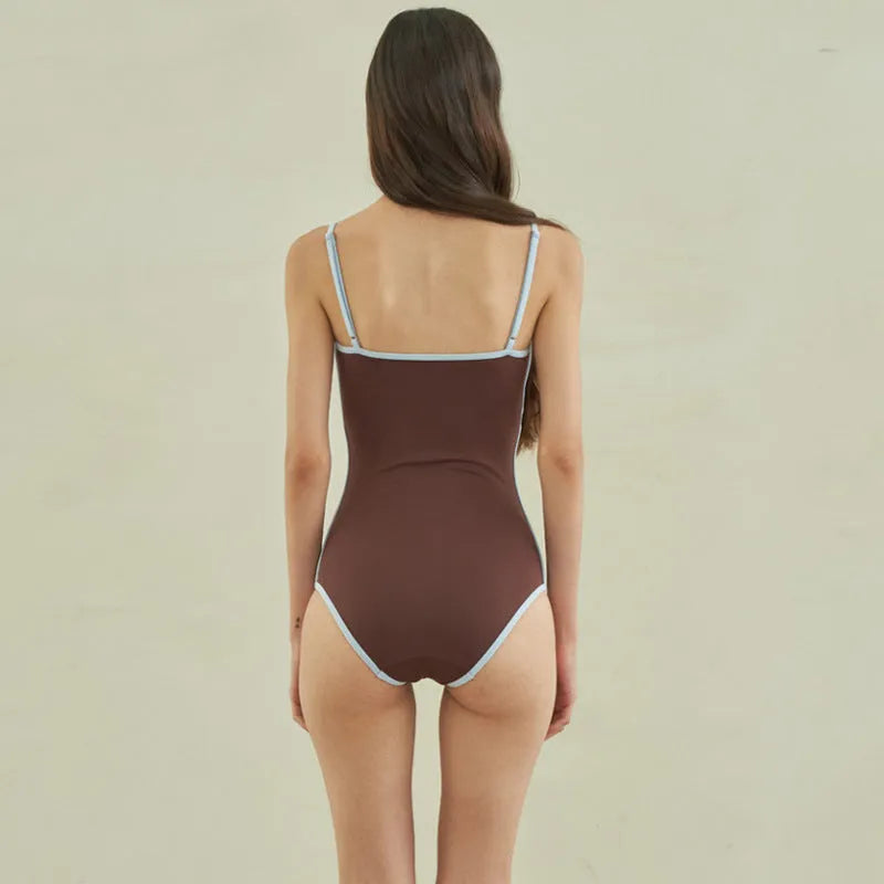 Brown women's triangle one-piece swimsuit on a hanger, sizes M L XL available.