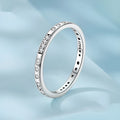 Simple silver Moss Password I Love You ring with oxidised black finish, shown on a model's finger.