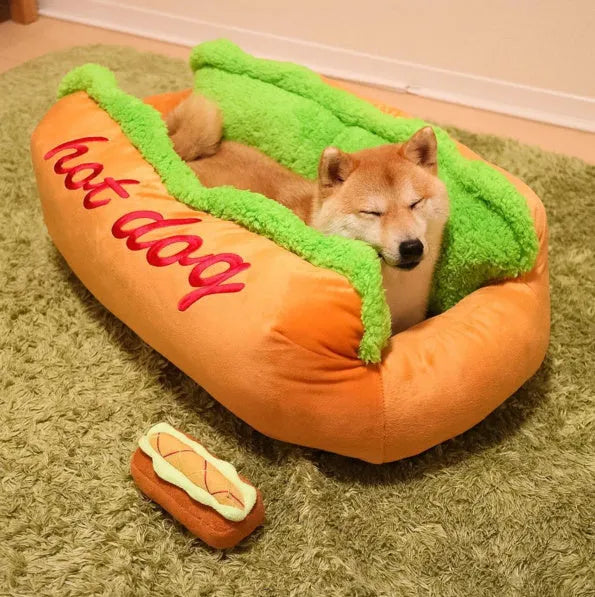 A soft flannelette hot dog bed for pets with a removable mat and anti-slip base, shown in a home setting.