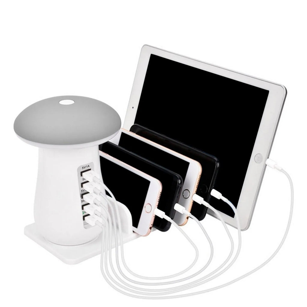White mushroom-shaped LED desk lamp with a 5-port USB charging station at its base on a wooden table.