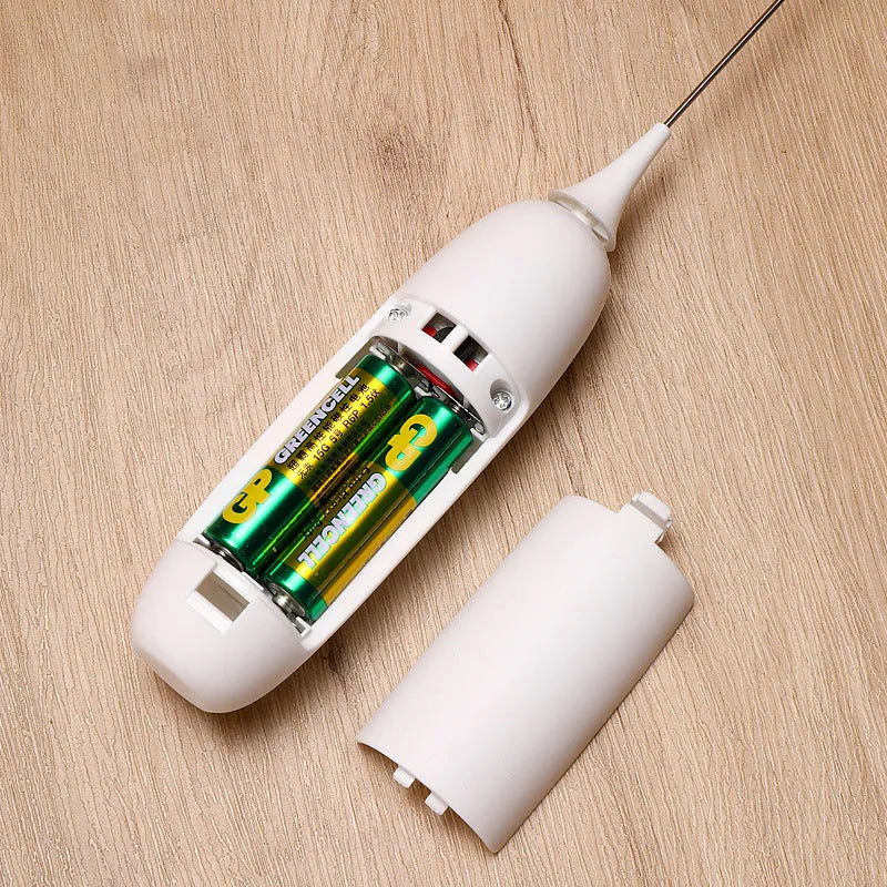 A black and a white hand-held electric milk frother for coffee, displayed on a kitchen counter.