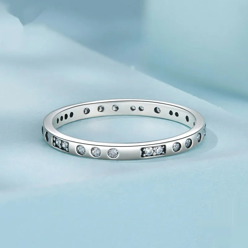Simple silver Moss Password I Love You ring with oxidised black finish, shown on a model's finger.