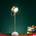 Clear glass dimmable desk lamp with touch switch on a wooden desk.