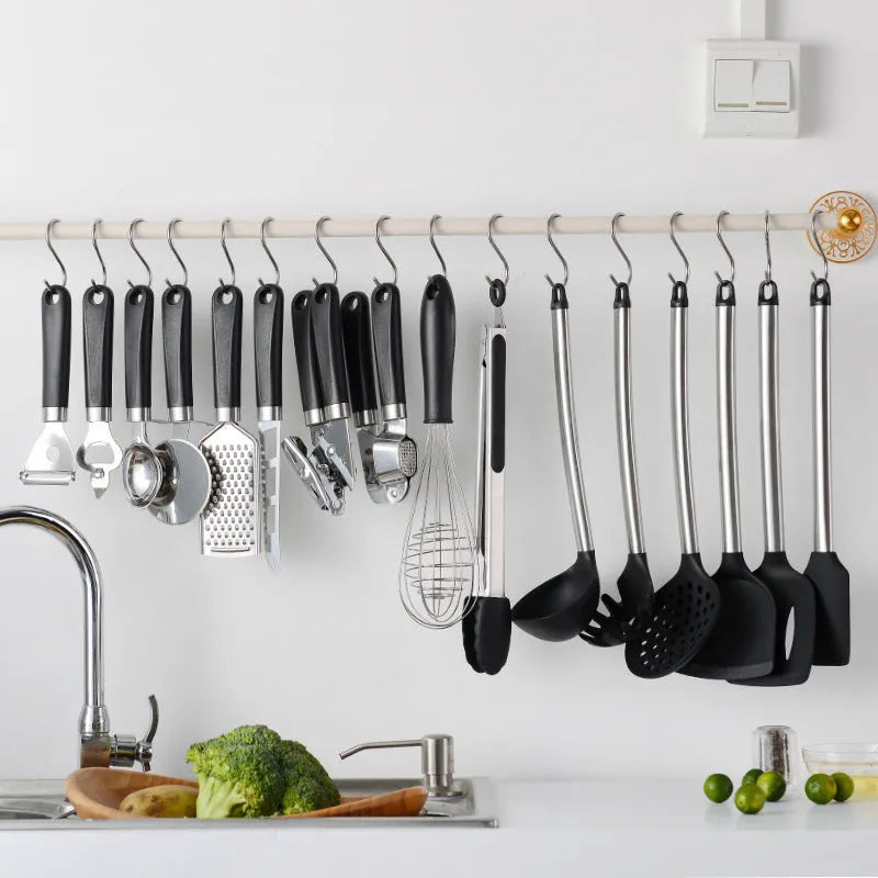 Black silicone kitchen utensil set with stainless steel handles showing 16 cooking tools