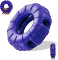 Blue natural rubber tyre-shaped dog chew toy and slow feeder with oval openings for treat dispensing.