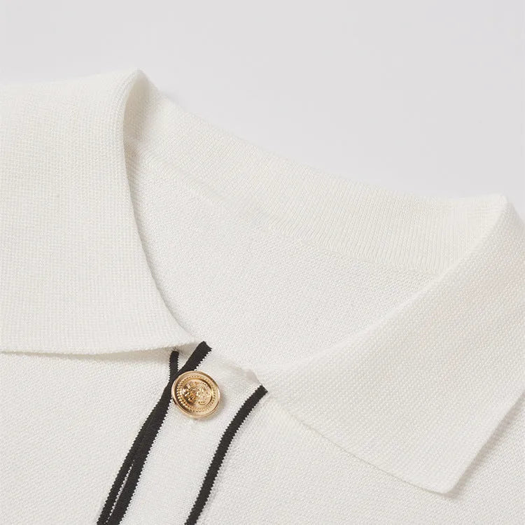 White short-sleeve cardigan with dark contrast lapels, laid flat.