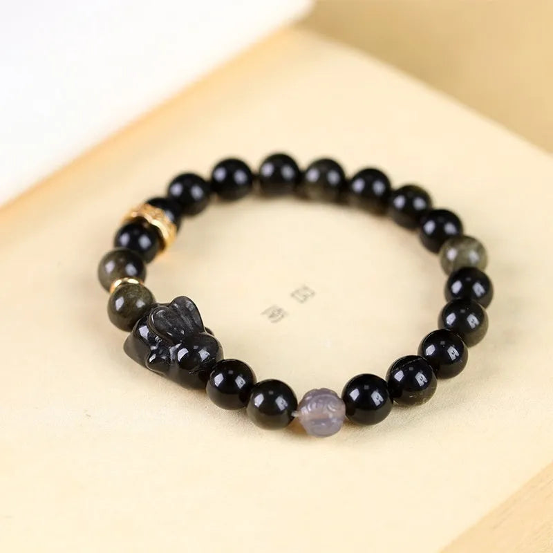 Handmade lying rabbit charm bracelet in Jin Yaoshi or Silver Yaoshi with 8mm or 10mm beads and grey agate accents.