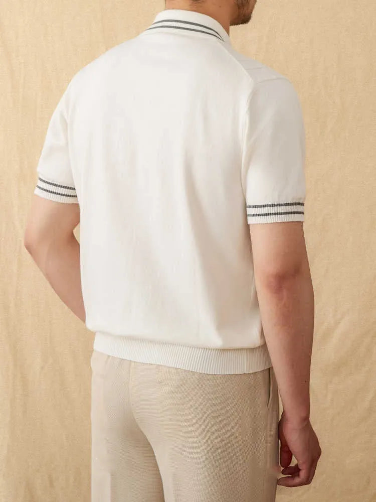 Man wearing a knitted apricot-coloured polo shirt with a lapel collar and short sleeves.