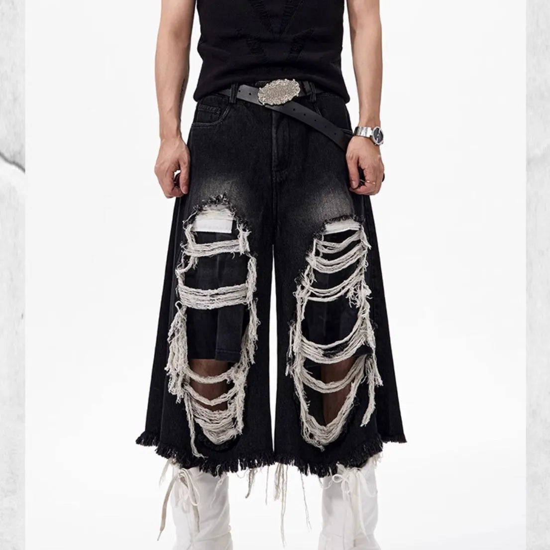 Black cropped wide leg jeans with ripped patch details and mid-high waist