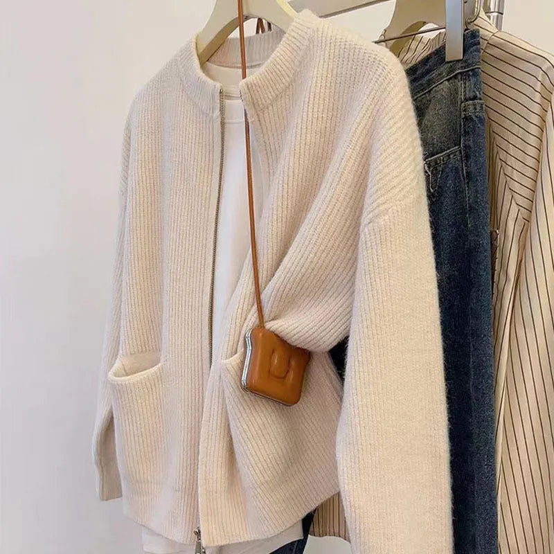 Beige viscose fibre sweater coat cardigan with long sleeves laid flat.