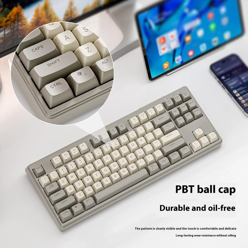 Free Wolf M87 wireless Bluetooth keyboard in blueberry colour on a desk, showing compact 87-key layout.