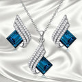Women's alloy necklace and earring set with glass pendant featuring cross chain design