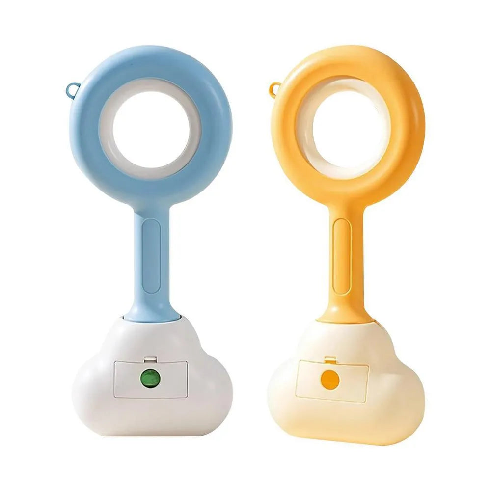 White blue and beige coloured cloud jaw design dog pooper scooper on a green lawn.