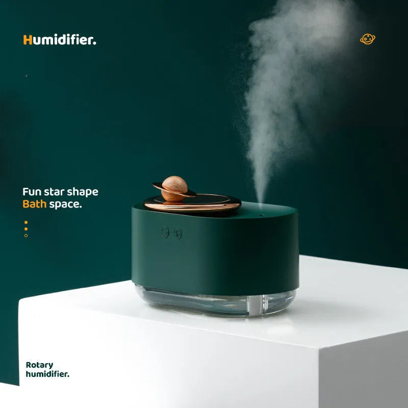 Planet-shaped rotating humidifier with night light in green, pink or white colours showing USB charging port