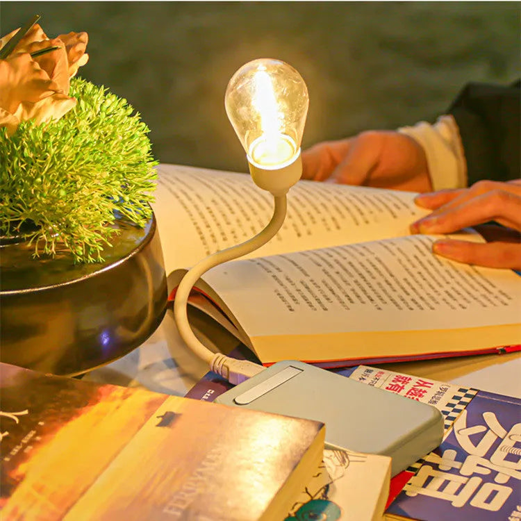 Folding USB rechargeable night light with glowing tungsten filament bulb.