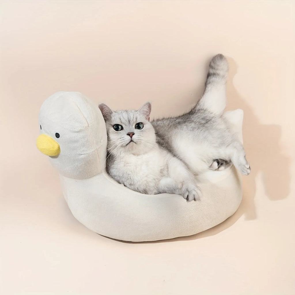 Blue duck-shaped fluffy pet bed for a small dog on a wooden floor.