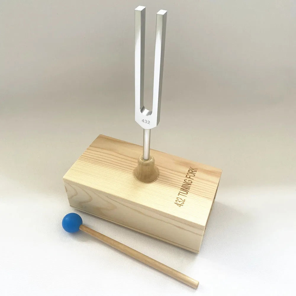 432Hz aluminium tuning fork and small speaker set on kraft paper packaging