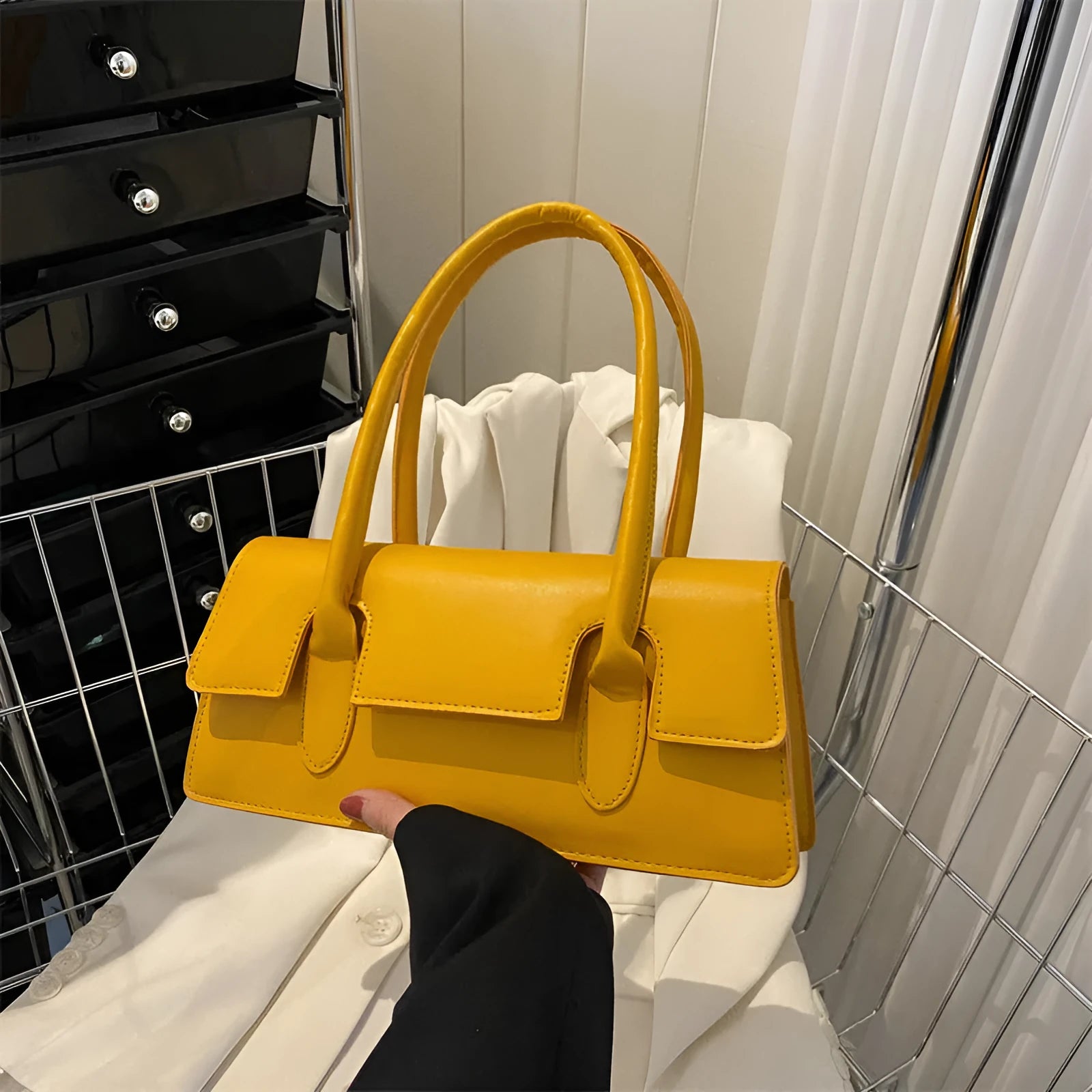 Women's small square bag in horizontal shape with single shoulder strap and document organisation interior