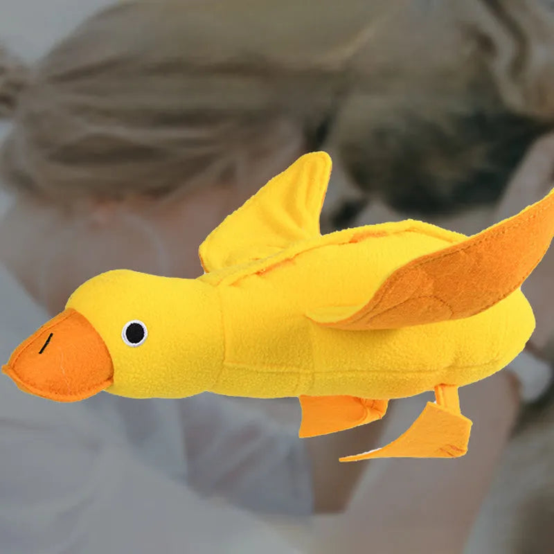 Yellow teddy dog toy with central duck doll, featuring a squeaker and treat leak compartment.