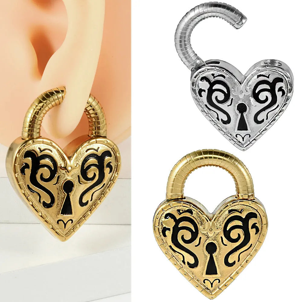 Close-up of a women's stainless steel heart-shaped ear piercing in a gold colour finish.