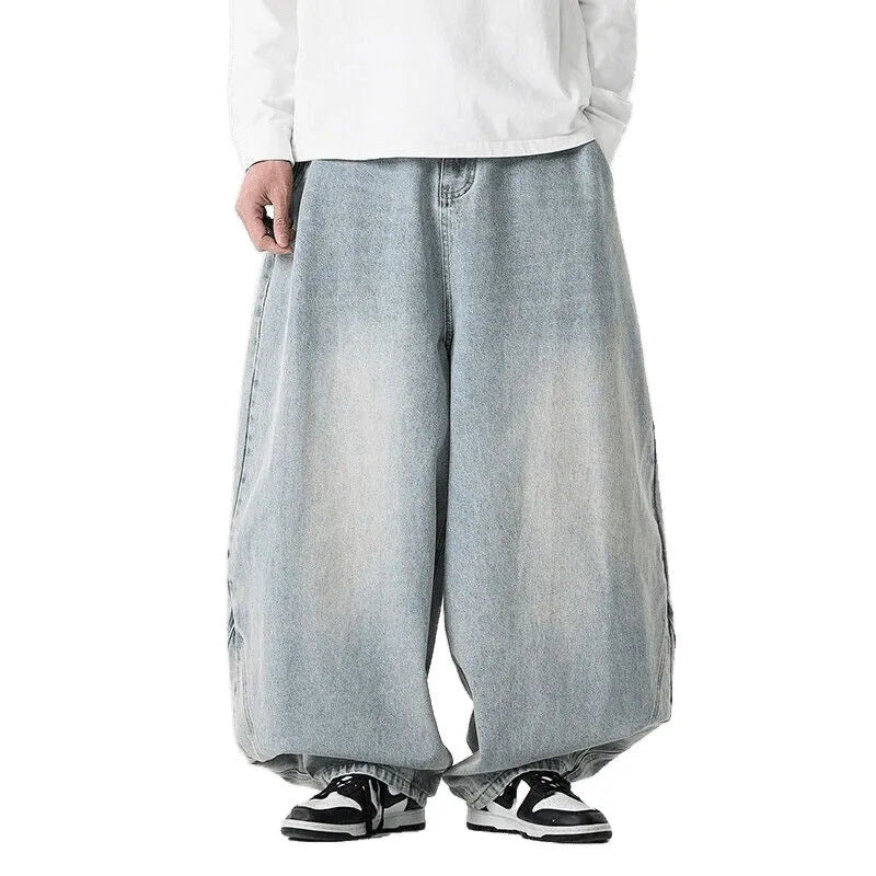 Men's plus size baggy blue jeans with wide straight legs on a hanger.