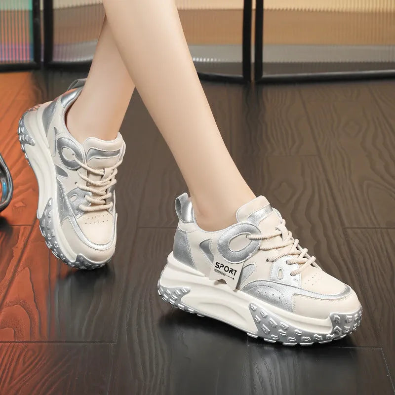 Pair of thick-soled leather sports casual shoes with wedge heels and front lace-up fastening.