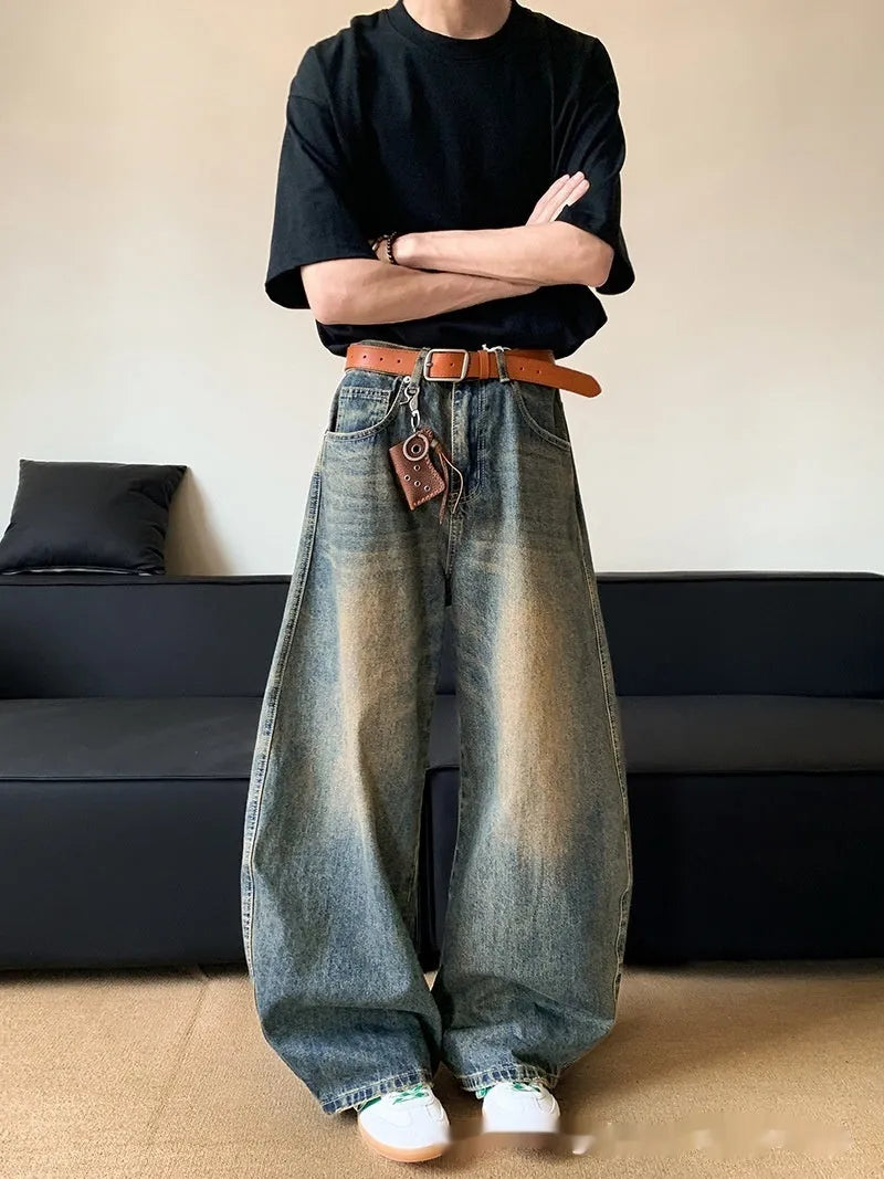Man wearing retro blue distressed wide-leg denim jeans with a slimming fit and mid waist design.