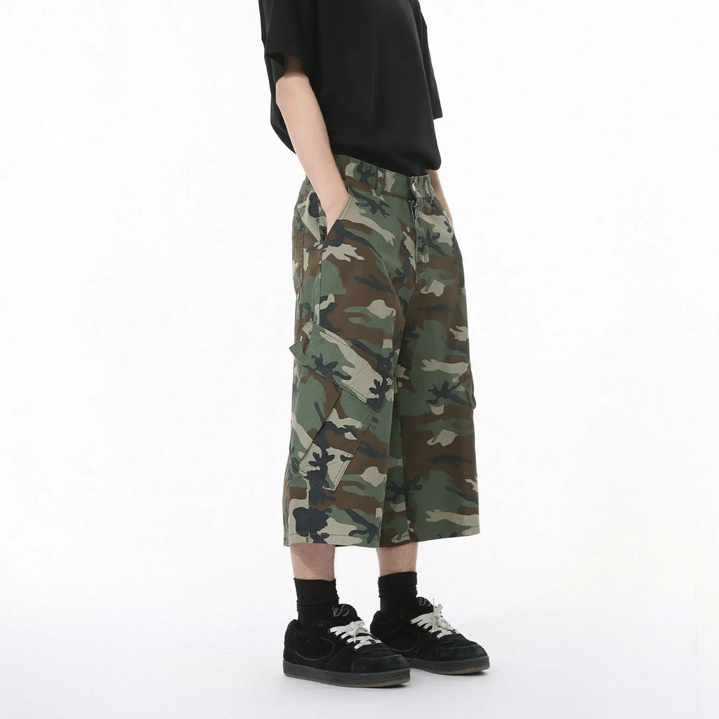Men's loose fit camouflage cotton jeans with wide legs, cropped length, and a large side pocket.