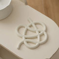 Ceramic heat proof mat in irregular shape on dining table