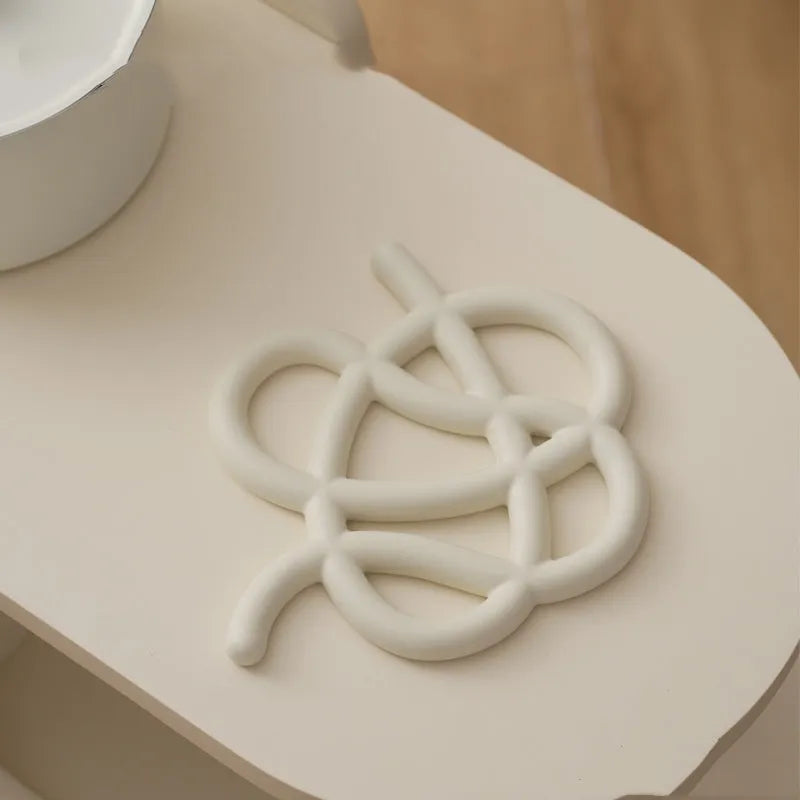 Ceramic heat proof mat in irregular shape on dining table