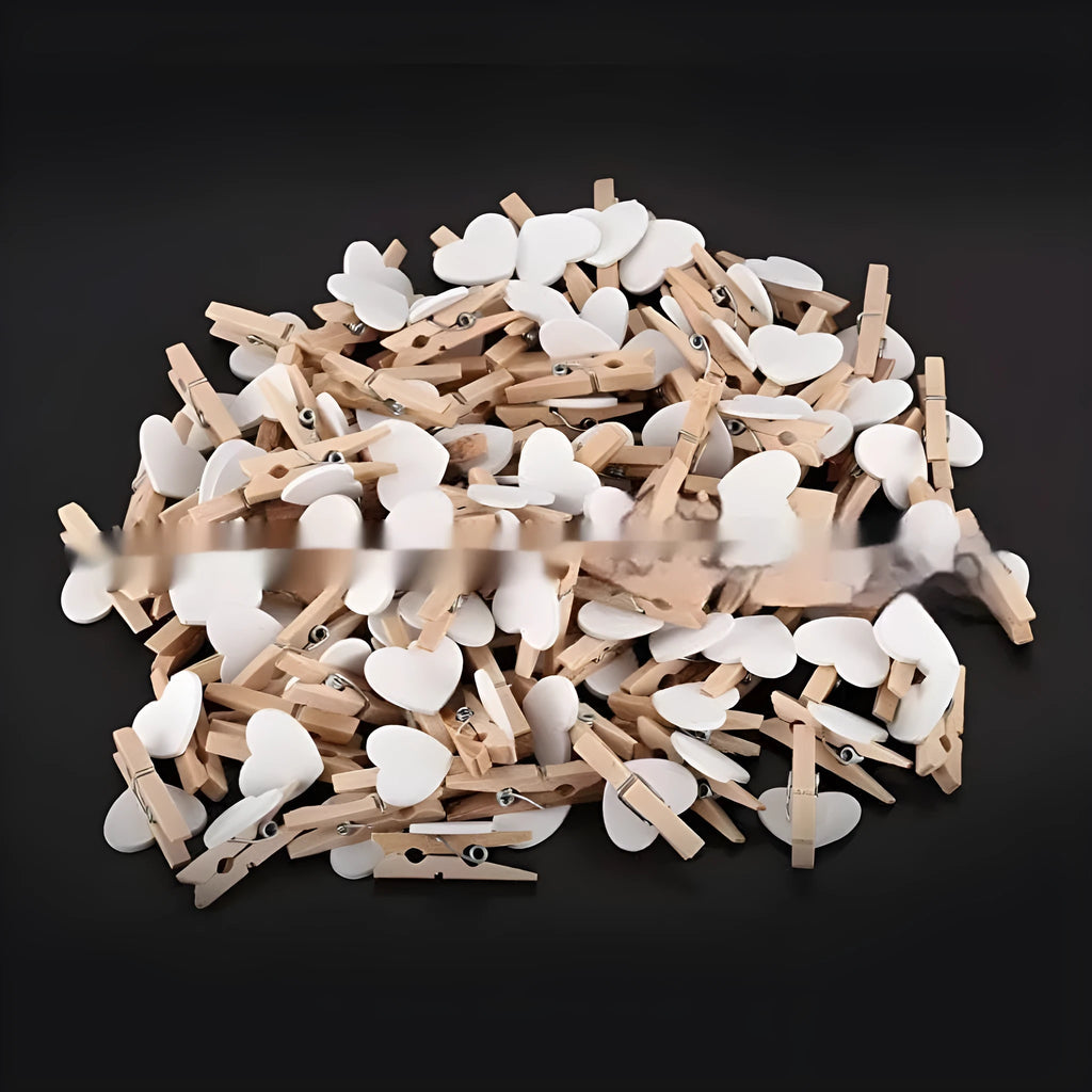Five solid wood heart-shaped clips in red, rose red, and white colours on a natural background.