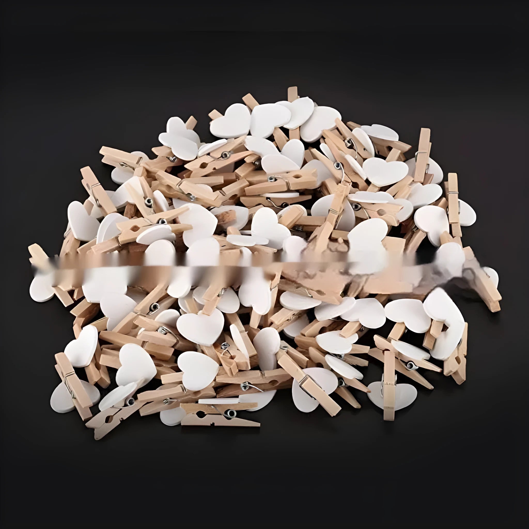 Five solid wood heart-shaped clips in red, rose red, and white colours on a natural background.