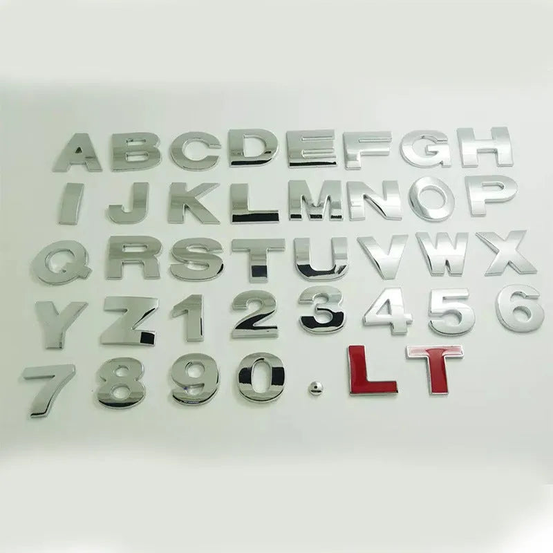Close-up of a silver metal zinc alloy 3D letter 'A' car bumper sticker, approximately 2.5cm in size.