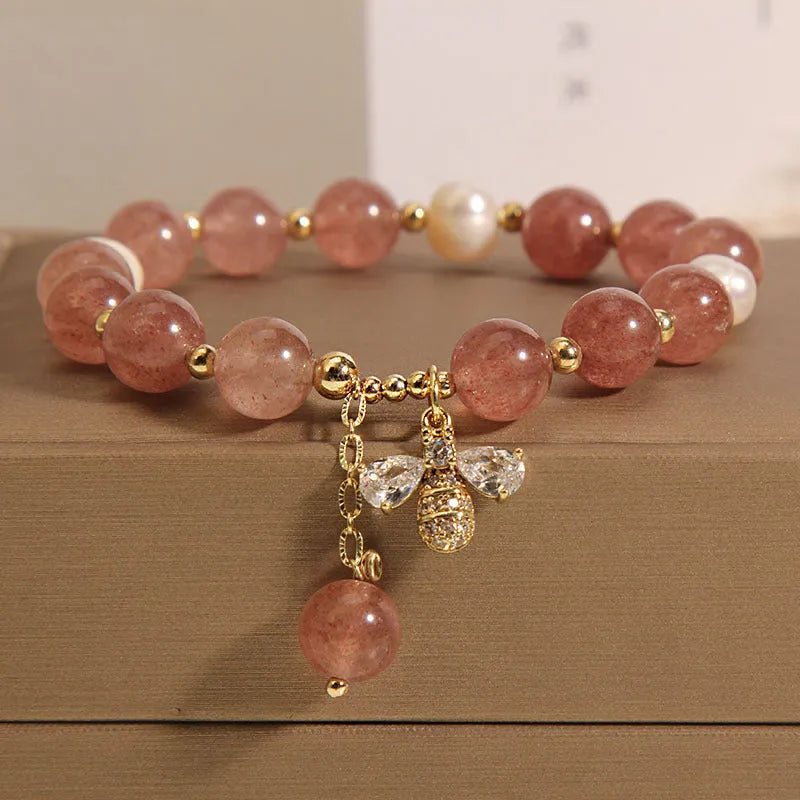 Women's bracelet with freshwater pearls, strawberry quartz beads, zircon accents, and an alloy clasp.